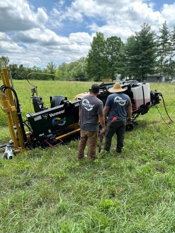 Two ProTek installation specialists looking at horizontal drill